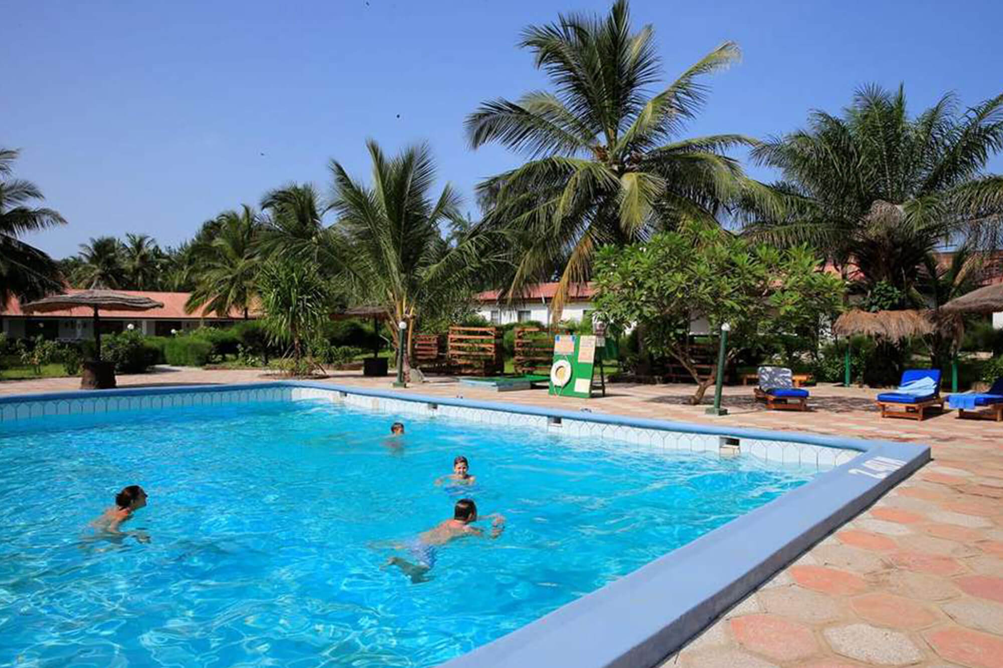 Zwemmen in het zwembad van het Holiday Beach Club hotel, Gambia